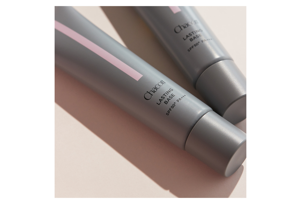 Kem Nền Chống Nắng Chacott Lasting Base SPF 50+ PA+++ 42g Màu 550 được thiết kế tinh tế với bao bì màu xám và họa tiết hồng, phù hợp cho việc tạo lớp nền hoàn hảo và bảo vệ da khỏi tia UV.